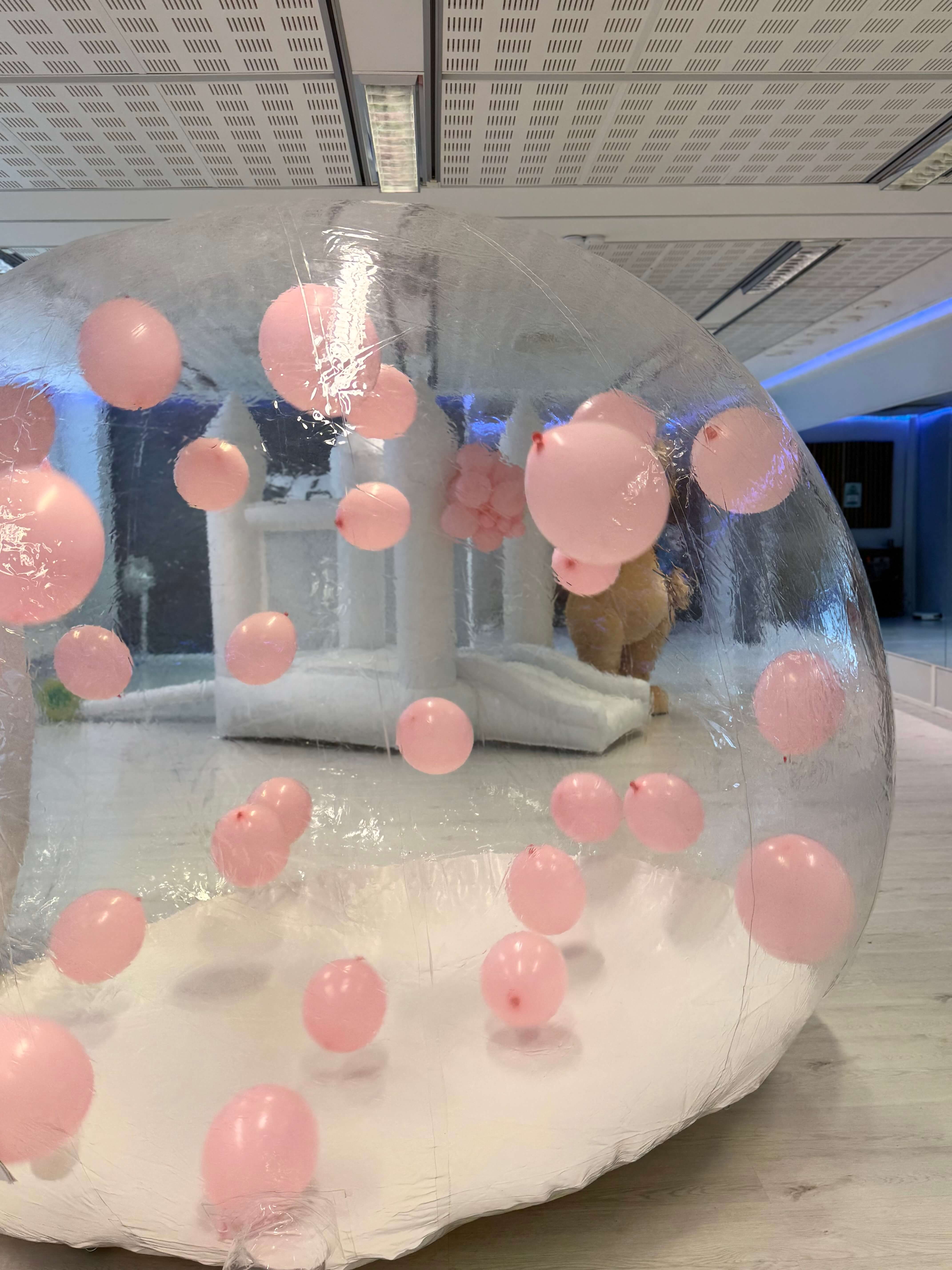 White inflatable bubble house filled with pink balloons – unique party attraction in Espoo, Uusimaa, Finland.