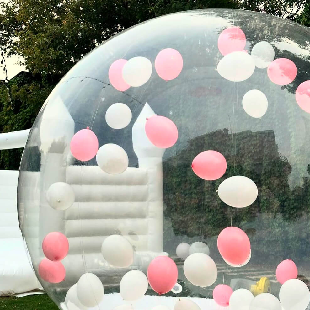 White inflatable bubble house filled with pink balloons – unique party attraction in Espoo, Uusimaa, Finland.